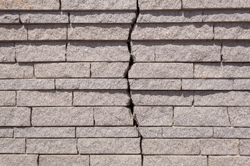 A large crack in the wall of granite slabs