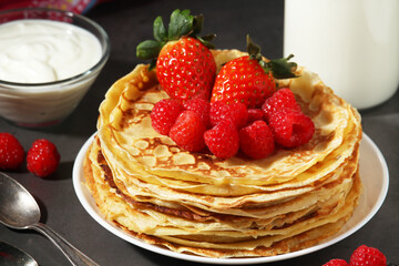 Russian cuisine national dish bliny with fresh berries	
