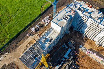 Top view of the building under construction and the surrounding area. Shooting from a drone.