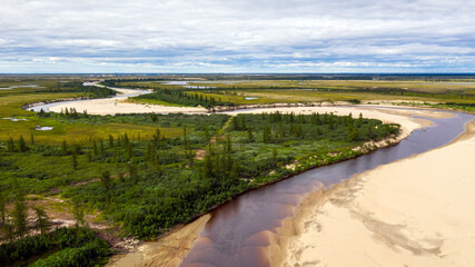 Landscape of the forest-tundra and the sandy river bank, bird's eye view.Arctic Circle, tunda. Beautiful landscape of  tundra from a helicopter.