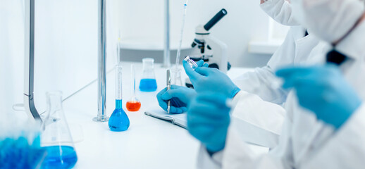 Fototapeta premium close up. group of scientists testing the results of a new vaccine .