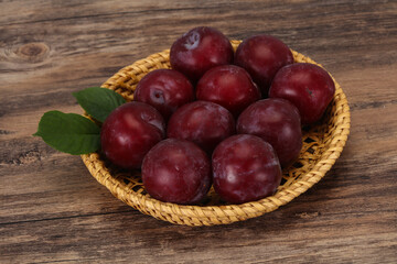 Plum heap in the wooden basket