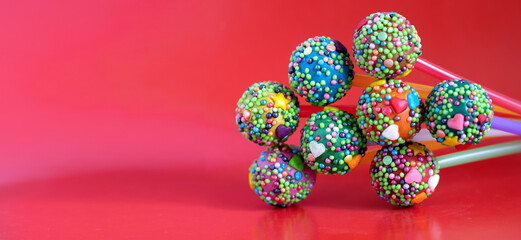 Image of tasty candy on a stick on a red background