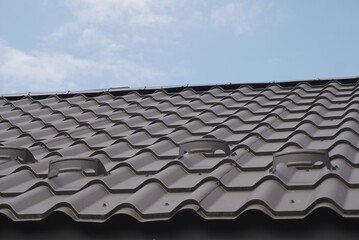 Fototapeta premium Black Metal Tile Roof. Roof Metal Sheets.