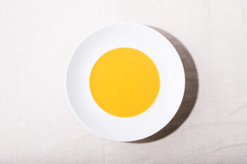 Carrot puree soup in ceramic plate