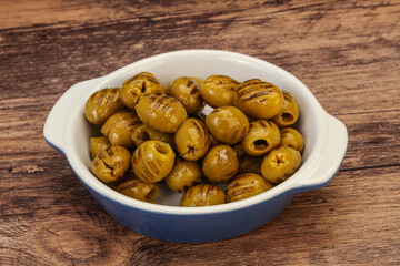 Green grilled olives in the bowl