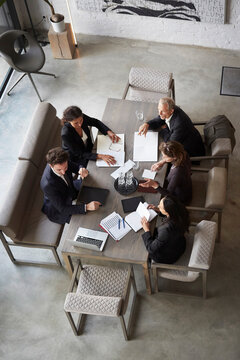 High angle view of customers and lawyers planning during meeting at office