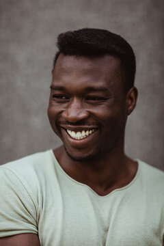 Close-up of happy man looking away while standing outdoors