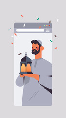 arabic man holding lantern celebrating online birthday party celebration self isolation quarantine concept smartphone screen mobile app vertical portrait vector illustration