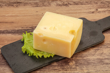 Emmental cheese over wooden board