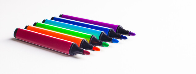 Set of open felt-tip pens of different colors close-up. Side view.