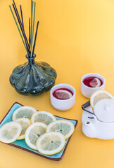 Red tea with lemon on a yellow background