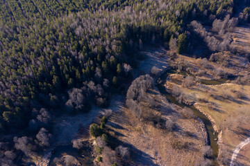 Drone shot flying on spring river in forest