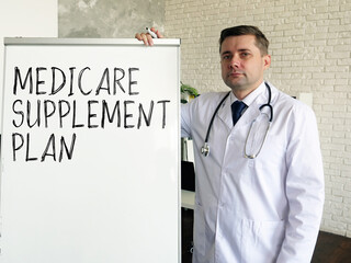 The doctor talks about medicare supplement plan. - obrazy, fototapety, plakaty