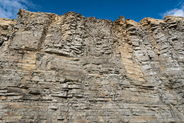 Chalk stone wall texture on sunny summer day