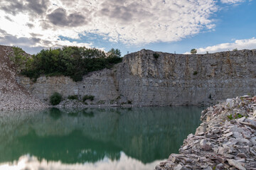 Fototapeta premium Green stone quarry lake on summer day
