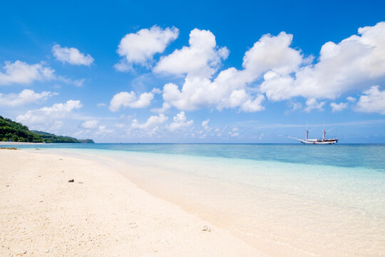 A traditional wooden Bugis pinisi ship moored off Nailaka beach, Rhun, Banda Islands, Maluku, Spice Islands, Indonesia