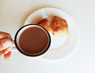Cup of coffee with puff bun on the plate,photo