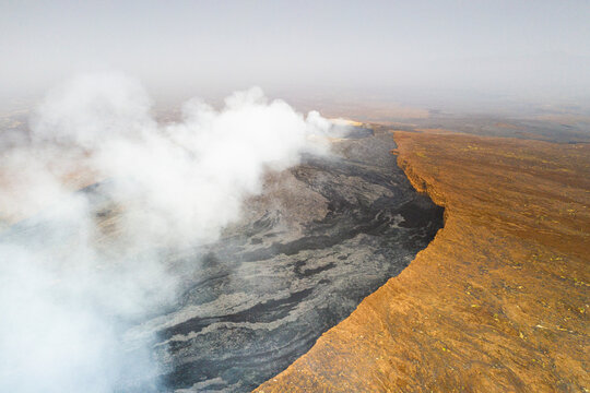 Arid soil on edge of the smoky Erta Ale volcano from above, Danakil Depression, Afar Region, Ethiopia