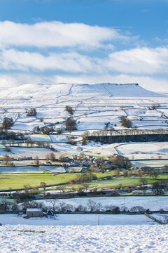 Fresh snow and winter sunshine covering the fell tops in Wensleydale around Nappa Scar and Addlebrough, North Yorkshire