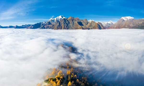 Fog covers the Valmalenco (Val Malenco) with the Disgrazia in the background and Brioken spectre, Valtellina, Lombardy