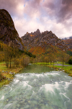 Torrent surmounted by mountains at sunrise, Valmasino, Valtellina, Lombardy