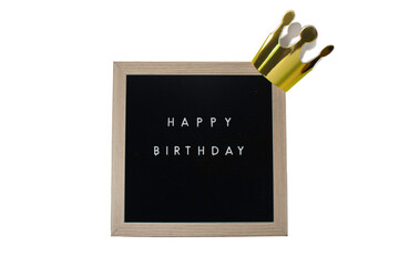 A Sign That Says Happy Birthday With a Gold Crown on Top on a White Background