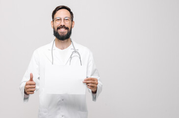 close-up portrait of young smiling male doctor in uniform with stethoscope reading medical document, shows like. medical concept