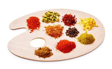Set of spices on wooden board. Palette with colorful spices isolated on white background.