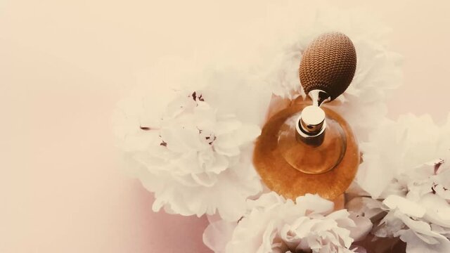 Vintage perfume bottle with peony flowers, chic fragrance scent as luxury cosmetic, retro fashion and beauty product backgrounds