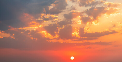 Fototapeta premium Beautiful colorful sunset sky with orange clouds. Nature sky background.