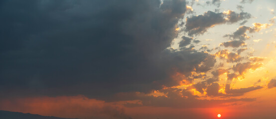 Beautiful colorful sunset sky with orange clouds. Nature sky background.