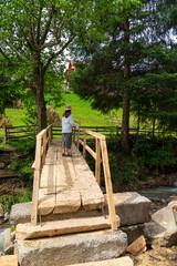 Woman tourist on the forest footbridge.