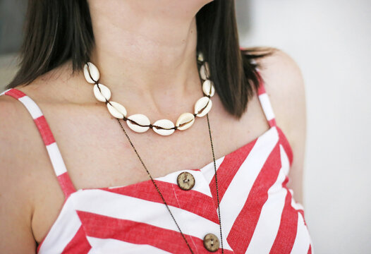 woman wearing stylish summer necklace with white shells - greek jewelry - summer fashion
