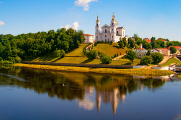 Fototapeta premium Vitebsk,Belarus - 18 July 2020 : Holy Assumption Cathedral of the Assumption on the hill and the Holy Spirit convent and Western Dvina River. Vitebsk, Belarus
