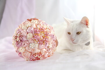 Wedding bouquet of ribbons and jewelry and wedding cat