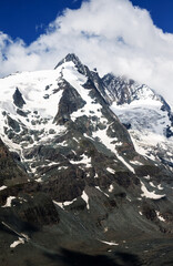 spectacular view of clouds over the snow covered mountains at the summit of Grossglockner in the austrian alps