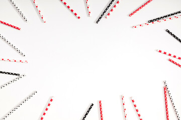 Summer cocktail party, happy vacation concept. Various paper straws on white background. Striped cardboard tubes for cocktails. Flat lay, top view, copy space.
