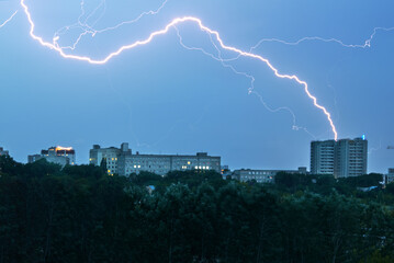 lightning strike at cloud city space. strike hit building apartments. urban landscape.