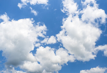 Obraz na płótnie Canvas Blue sky background with white fluffy clouds