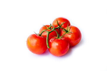 On a white background. No isolation. Red tomato on a green branch. There is a shadow.