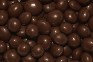 Background chocolate jelly close-up, raisins or peanuts in chocolate