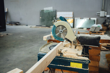 Electric circular saw in a wood workshop