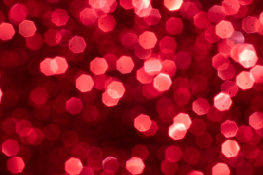 Red glitter festive background with bokeh lights. Celebration concept for Holidays and anniversary.