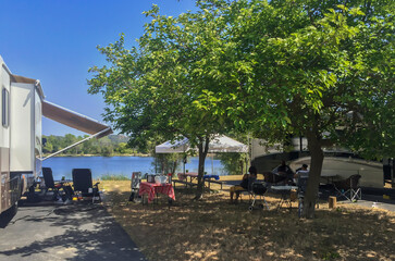 Fototapeta na wymiar Rv camping next to a lake on a sunny summer day
