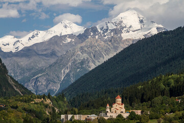 Church in Mestia, Georgia with he Caucasus Mountains in the background.
