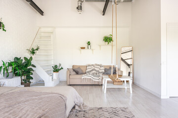 Luxury bedroom design in a rustic cottage in a minimalist style. white walls, panoramic windows, wooden elements of decoration on the ceiling, rope swings in the middle of a spacious room