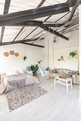 Luxury bedroom design in a rustic cottage in a minimalist style. white walls, panoramic windows, wooden elements of decoration on the ceiling, rope swings in the middle of a spacious room