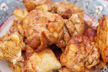 Chicken shashlik. Shashlik or Shish kebab popular in Eastern Europe. Marinated shashlik preparing on a barbecue grill over charcoal. Chicken hip barbecue. Fried meat in plate.