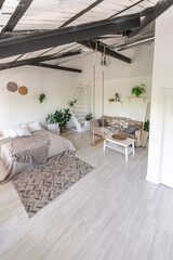 Luxury bedroom design in a rustic cottage in a minimalist style. white walls, panoramic windows, wooden elements of decoration on the ceiling, rope swings in the middle of a spacious room